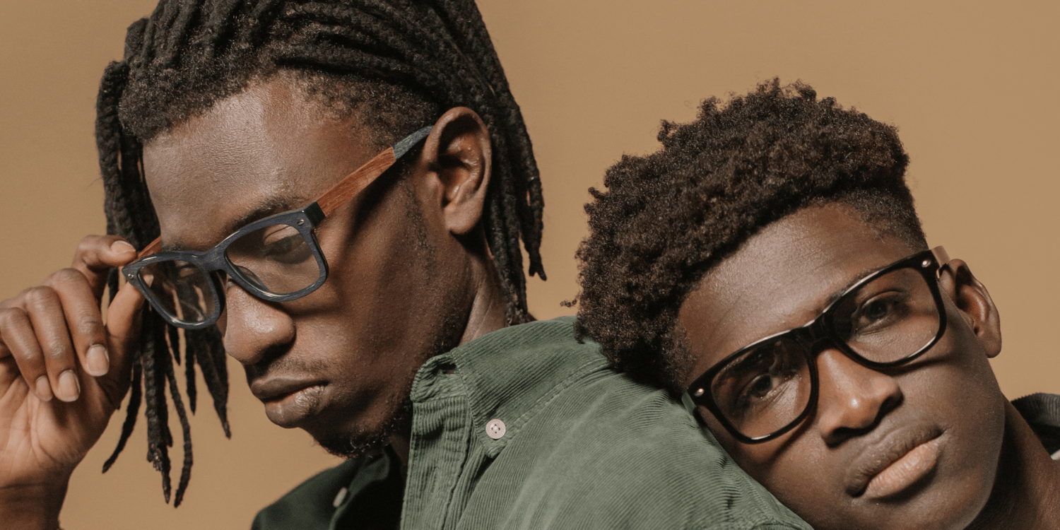 two young stylish black men wearing trendy eyeglasses